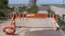 A sign indicates the closure of the pier in Kincardine, Ont. amid high waves on Friday, Sept. 4, 2020. (Scott Miller / CTV News)