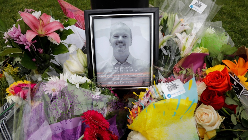 An impromptu memorial for Dr. Walter Reynolds, who died after he was attacked in an examination room rests outside the Village Mall walk-in clinic in Red Deer, Alta., on August 11, 2020. THE CANADIAN PRESS/Jeff McIntosh