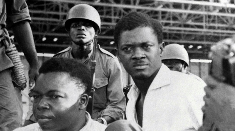 Post-independence Congo's first prime minister, Patrice Lumumba, right, pictured after being seized by troops in December 1960. To the left is Joseph Okito, the vice president of the Senate, who like Lumumba would also be murdered. (AFP)