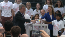 Ottawa Mayor Jim Watson and Ontario Transportation Minister Caroline Mulroney officially launch the Confederation Line LRT, Sept. 14, 2019. They are surrounded by children whose names were chosen for LRT train cars. (CTV News Ottawa)