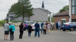 Residents maintain physical distancing as they line up to vote in the New Brunswick provincial election at St. Mark's Catholic Church in Quispamsis, N.B. on Monday, Sept. 14, 2020. (THE CANADIAN PRESS/Andrew Vaughan)