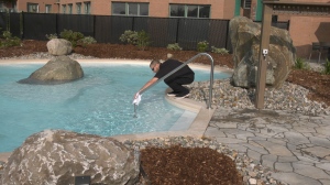 Dominic Morin tests the water at Koena Spa and Nordic Bath in Aylmer, Que. The spa opened Monday, Sept. 14, 2020. (Leah Larocque / CTV News Ottawa)