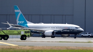 A Boeing 737 MAX jet taxis after landing at Boeing Field following a test flight Monday, June 29, 2020, in Seattle. (AP Photo/Elaine Thompson)