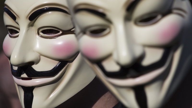 Two people are seen wearing Guy Fawkes masks in this stock image from Shutterstock. 