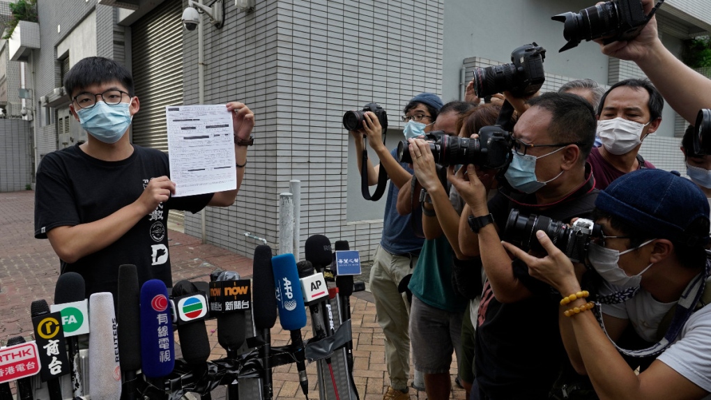 Joshua Wong displays a bail paper