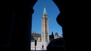 A man walks outside Parliament buildings in Ottawa, Monday September 21, 2020. (THE CANADIAN PRESS/Adrian Wyld)