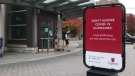 Students walk by a sign at Queen's University in Kingston, Ont., urging everyone to follow COVID-19 guidelines, Sept. 29, 2020. (Kimberley Johnson / CTV News Ottawa)