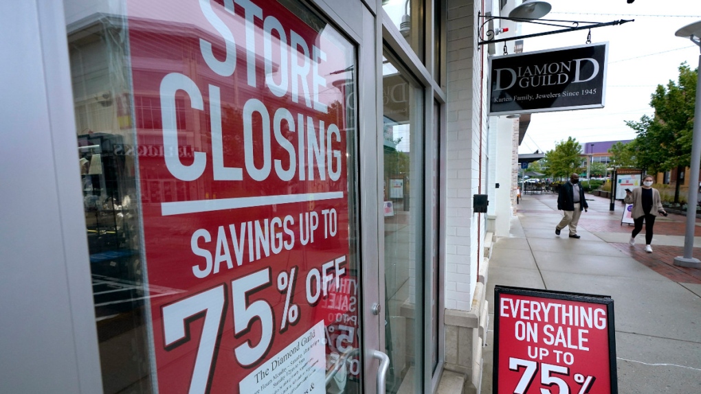 Business storefront with store closing, sale signs