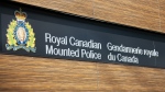 A sign for the Royal Canadian Mounted Police in English and French along with the crest of the RCMP. (Shutterstock)