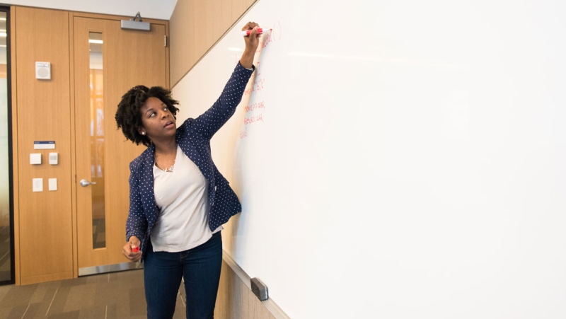 A teacher is seen writing on a whiteboard in this undated file photo. (Photo by Christina Morillo from Pexels)