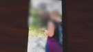 This blurred image from video shows two people distributing anti-abortion flyers in London, Ont.