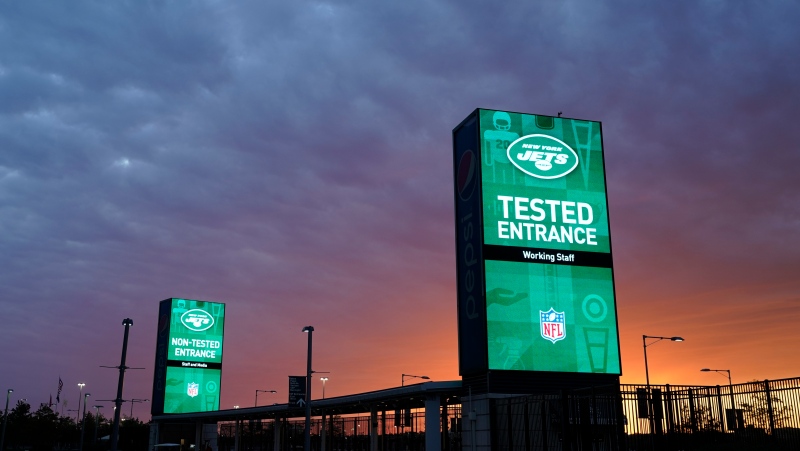 Security stands indicate entrances for tested and non-tested personnel entering MetLife Stadium before an NFL football game between the New York Jets and the Denver Broncos during the coronavirus pandemic, Oct. 1, 2020, in East Rutherford, N.J. (AP Photo/Frank Franklin II)