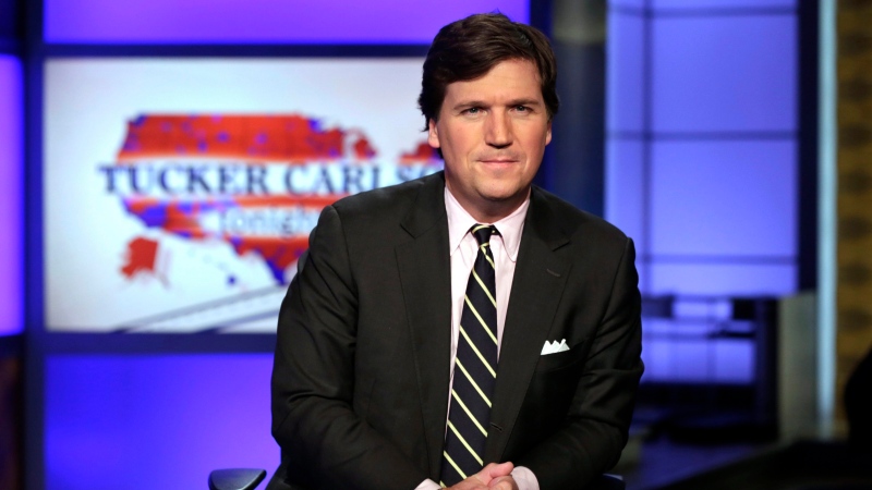 In this March 2, 2017 file photo, Tucker Carlson, host of "Tucker Carlson Tonight," poses for photos in a Fox News Channel studio, in New York. (AP Photo/Richard Drew, File)