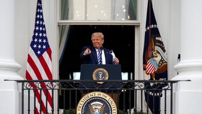 President Donald Trump speaks from the Blue Room Balcony of the White House to a crowd of supporters, Saturday, Oct. 10, 2020, in Washington. (AP Photo/Alex Brandon)
