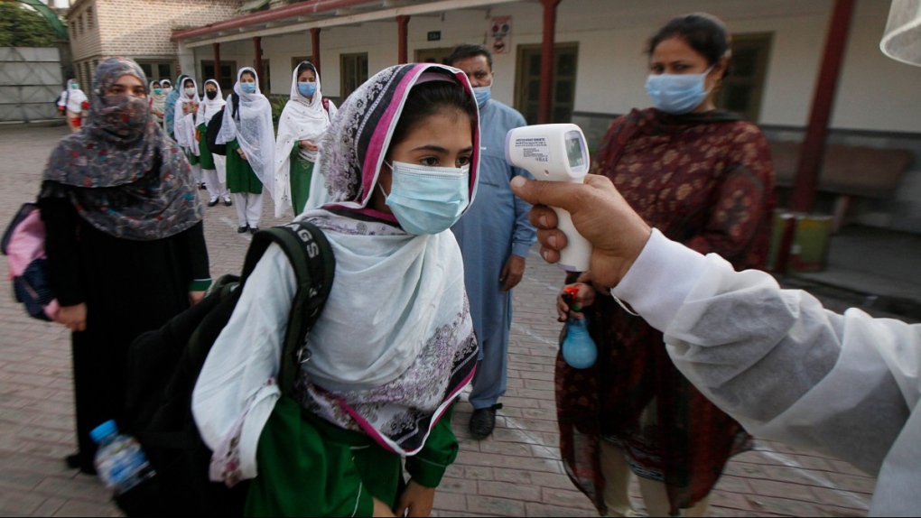 Checking temperatures at a school in Peshawar