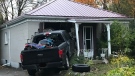 A pickup truck was left crashed into a home on Elliot Street on Monday, Oct. 19, 2020. (Sean Irvine / CTV London)