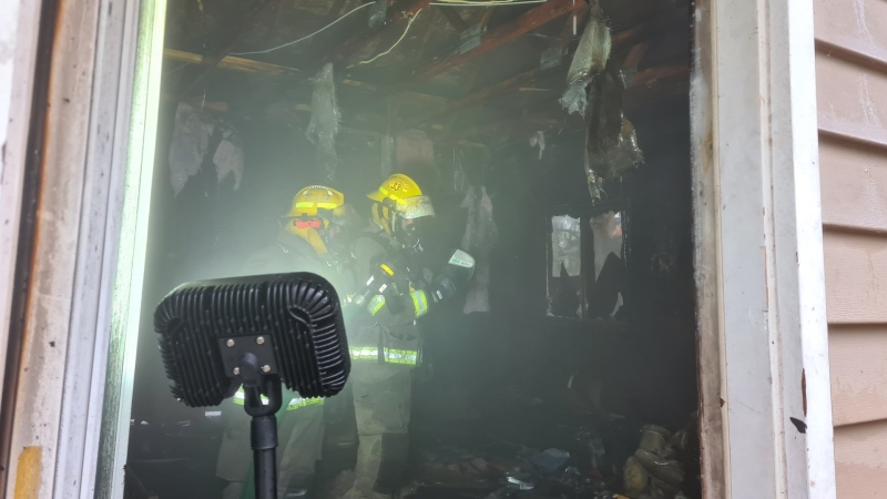 Firefighters survey the damage after a fire inside the garage of a home in Adjala-Tosorontio, Ont. on Sun. Nov. 1, 2020 (Adjala-Tosorontio Fire)