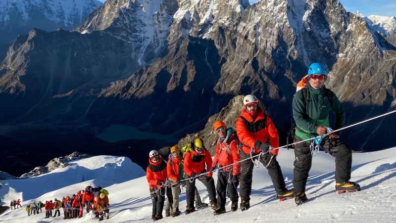This photo provided by Seven Summit Treks, shows a team of mountaineers from Bahrain who were given special permission to scale Mount Lobuche in Nepal, Oct 3, 2020. (Seven Summit Treks via AP)