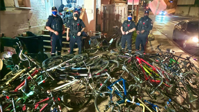 Ottawa police officers pose with dozens of stolen bikes that were seized in Centretown Nov. 7, 2020. (Photo provided by the Ottawa Police Service)