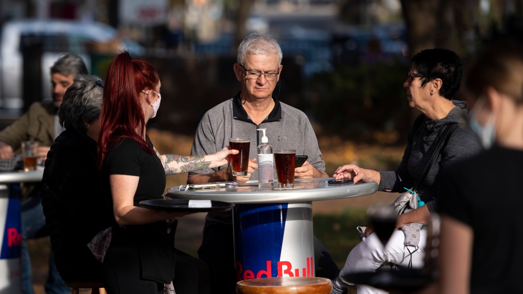 Patrons enjoy the warm weather on a pub patio