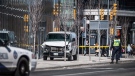 Police are seen near a damaged van in Toronto after a van mounted a sidewalk crashing into a number of pedestrians on Monday, April 23, 2018. THE CANADIAN PRESS/Aaron Vincent Elkaim