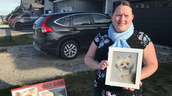 Laura Adlington of Woodstock, Ontario holds photo of her dog ‘Maggie’.  She’s been missing for 5 months, but a recent political decision may help find her. (Sean Irvine CTV News)