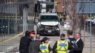 Police are seen near a damaged van in Toronto after a van mounted a sidewalk crashing into a number of pedestrians on Monday, April 23, 2018. THE CANADIAN PRESS/Aaron Vincent Elkaim