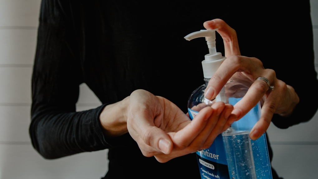 Hands using hand sanitizer