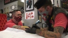 Adopt-a-Vet Founder Brad Krewench getting a poppy tattoo by Veteran/Border City Ink Tattoo Artist Troy Windibank in Windsor, Ont. on Tuesday, Nov. 10, 2020. (Chris Campbell/CTV Windsor)