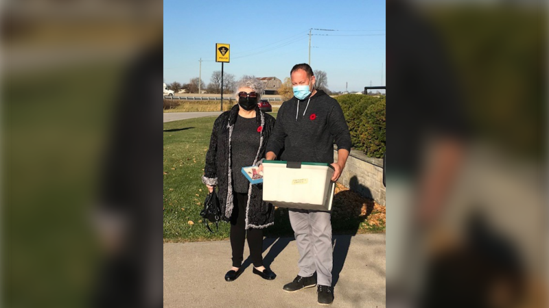 Detective Constable J. Paquette returned the "Mystery Tote" to Carol Briese in Lakeshore Ont., on Wednesday, Nov. 11, 2020. (courtesy Essex County OPP)