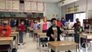 Holy Rosary Catholic School grade 3 students in London, Ont. "sing" O Canada by using sign language. (@MissAliZim/Twitter)