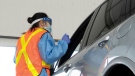 Ottawa Health personnel speaks with the driver before administering a COVID-19 test at a drive-through test centre in Ottawa, Friday, September 4, 2020. THE CANADIAN PRESS/Adrian Wyld