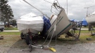 A sailboat leans against another one after it was blown over in Sunday's storm in Port Dover. (Marek Sutherland / CTV London)