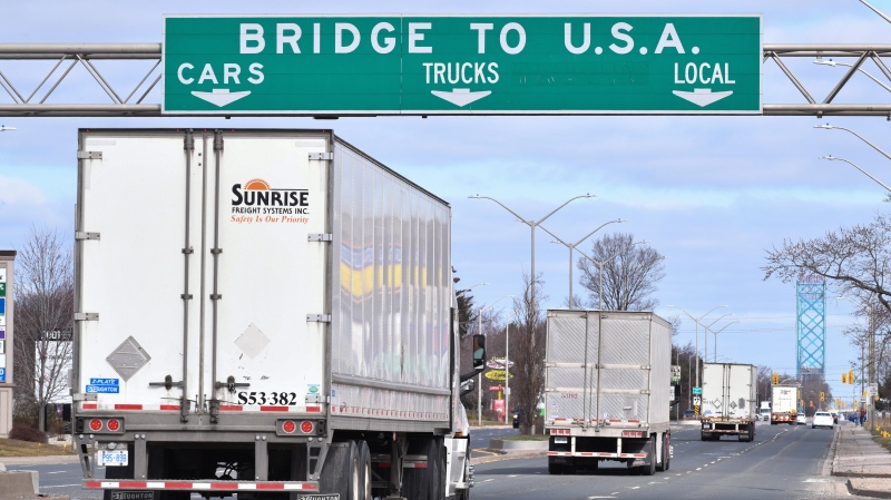 Transport trucks approach the Canada/USA border crossing in Windsor, Ont. on Saturday, March 21, 2020. THE CANADIAN PRESS/Rob Gurdebeke