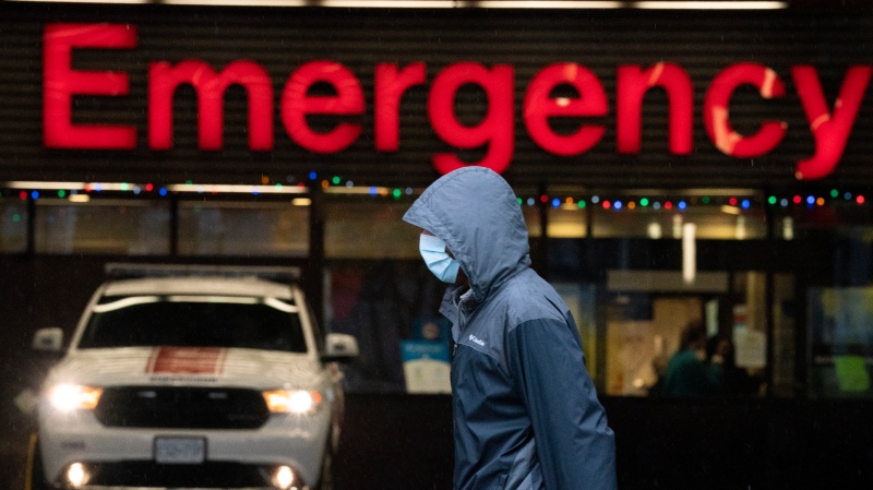A person wears a protective face mask to help prevent the spread of COVID-19 as they walk past the emergency department of the Vancouver General Hospital in Vancouver Wednesday, November 18, 2020. THE CANADIAN PRESS/Jonathan Hayward