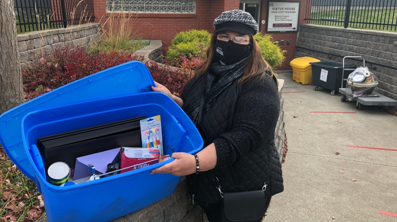 Baskeeter Bonnie Pacuta with a basket full of essentials for women at Hiatus House in Windsor, Ont. on Saturday, Nov. 21, 2020. (Alana Hadadean/CTV Windsor)