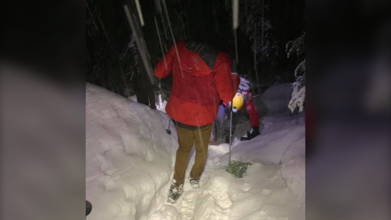 North Shore Rescue team member kicks steps into a snow-covered trail for a hiker who got lost on Nov. 22, 2020.