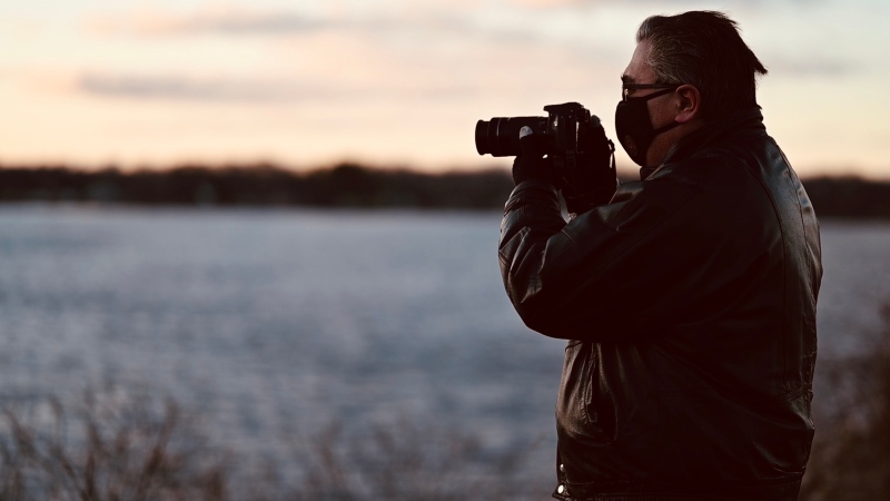 Greg Scriver takes a photo of a sunset along the Ottawa River. The Orléans man rediscovered his love for photography during the COVID-19 pandemic, taking photos of sunsets daily. (Joel Haslam / CTV News Ottawa)