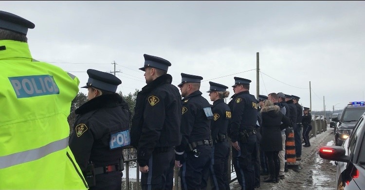 Members of the OPP and first responders give a final salute to a fellow officer killed in the line of duty. Innisfil, Ont., on Mon., Nov. 23, 2020. (Lexy Benedict/CTV News)