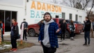 Owner of Adamson Barbecue, Adam Skelly gestures outside his restaurant in Etobicoke, Ont., Tuesday, Nov. 24, 2020. The owner of Adamson took to social media to announce he was opening for indoor dining against provincial lockdown orders. THE CANADIAN PRESS/Cole Burston