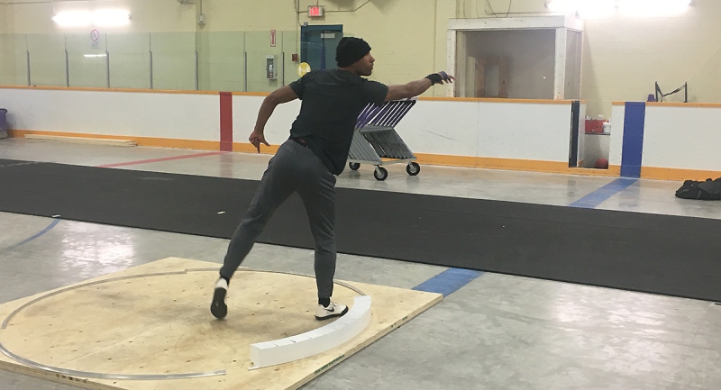 Olympian Damian Warner releases shot put as he trains in London, Ont. on Tuesday, Nov. 24, 2020. (Brent Lale / CTV News)