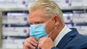 Ontario Premier Doug Ford puts his mask back on during the daily briefing at Humber River Hospital in Toronto on Tuesday November 24, 2020. THE CANADIAN PRESS/Frank Gunn