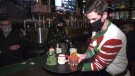 A server grabs some of the holiday libations available at the Miracle cocktail bar pop-up. Nov. 25, 2020. (CTV News Edmonton)