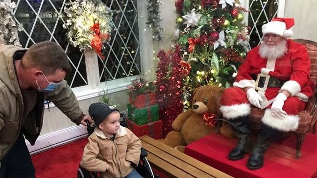 Johnny Hall of West Lorne, Ontario is the first visitor to see Santa Claus in his house at Victoria Park in London, Ontario on Friday, November 27, 2020. Hall is currently battling cancer (Sean Irvine CTV News) 