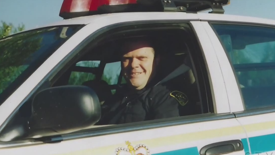 Photo of a young Marc Hovingh in a police car