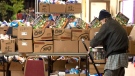 In this file photo, a recipient stacks his provisions in a cart at the Grant African Methodist Episcopal Church's Food Bank in Toronto on Friday March 20, 2020. (THE CANADIAN PRESS/Chris Young)