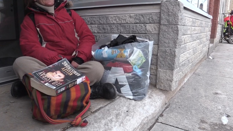 A person living with homelessness sits in a doorway in London, Ont.