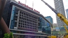 Workers prepare to install a new video board and signage outside of the Scotiabank Arena in Toronto on Wednesday, July 31, 2019. While the Maple Leafs and Raptors gear up for next season, Scotiabank Arena is getting a multimillion-dollar facelift. MLSE president and CEO Michael Friisdahl calls it a "reimagination" of the venue that opened in February 1999. THE CANADIAN PRESS/Neil Davidson