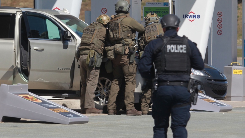 RCMP officers prepare to take a person into custody at a gas station in Enfield, N.S. on Sunday April 19, 2020. The Nova Scotia RCMP provided a partial timeline of what happened last weekend when a man posing as an RCMP officer killed 22 people before he was fatally shot by police on Sunday, a little over 12 hours after he started what would become one of the worst mass killings in Canadian history. THE CANADIAN PRESS/Tim Krochak