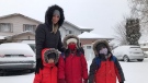 Chaza Zeatir and her children Eyad, Marwan and Ryan wait for a school bus in south London, Ont. during a significant snowfall on Tuesday, Dec. 1, 2020. (Sean Irvine / CTV News)